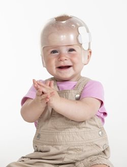 Image of baby girl wearing helmet