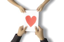 hands receiving greeting card