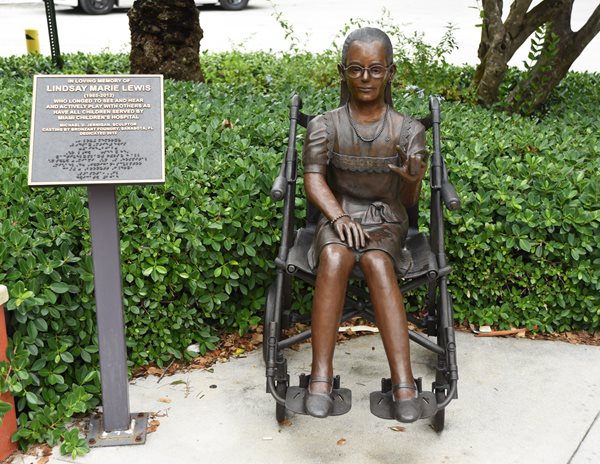 Sculpture of young girl in a wheelchair.