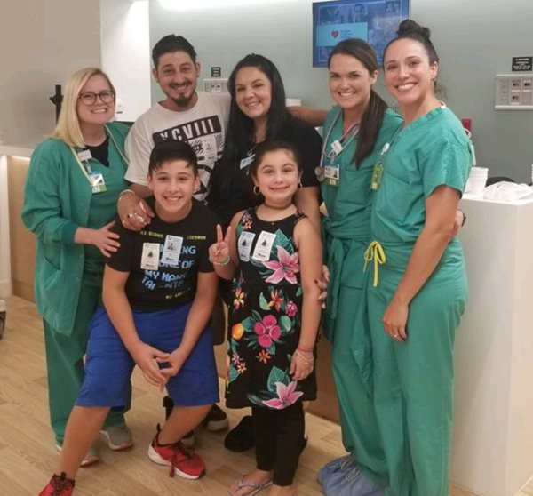 Emily Granados with her family and clinicians.