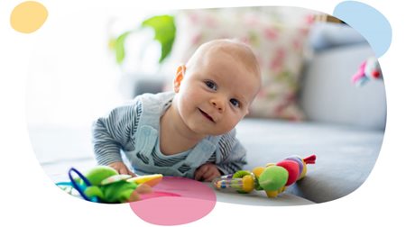 baby enjoying tummy time on the carpet.