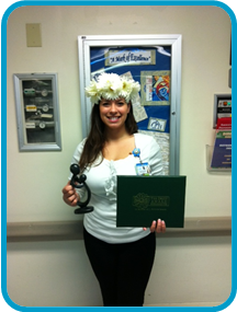 awardee wearing a headband of daisies, daisy award statue, and certificate.