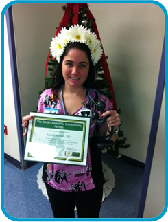 awardee wearing a headband of daisies, daisy award statue, and certificate.