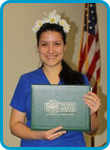 awardee wearing a headband of daisies, daisy award statue, and certificate.