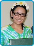 awardee wearing a headband of daisies, daisy award statue, and certificate.