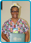 awardee wearing a headband of daisies, daisy award statue, and certificate.