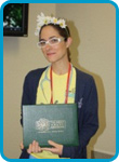 awardee wearing a headband of daisies, daisy award statue, and certificate.