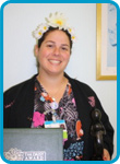 awardee wearing a headband of daisies, daisy award statue, and certificate.