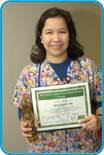 awardee wearing a headband of daisies, daisy award statue, and certificate.