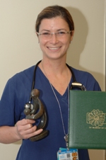 awardee wearing a headband of daisies, daisy award statue, and certificate.