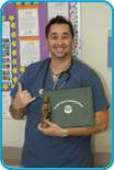 awardee wearing a headband of daisies, daisy award statue, and certificate.