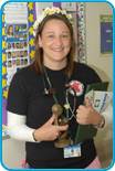 awardee wearing a headband of daisies, daisy award statue, and certificate.