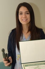 awardee wearing a headband of daisies, daisy award statue, and certificate.