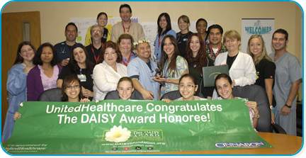 awardee wearing a headband of daisies, daisy award statue, and certificate.