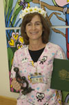 awardee wearing a headband of daisies, daisy award statue, and certificate.