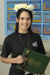 awardee wearing a headband of daisies, daisy award statue, and certificate.