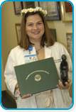 awardee wearing a headband of daisies, daisy award statue, and certificate.