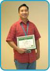 awardee wearing a headband of daisies, daisy award statue, and certificate.