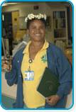 awardee wearing a headband of daisies, daisy award statue, and certificate.
