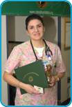 awardee wearing a headband of daisies, daisy award statue, and certificate.