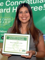 awardee wearing a headband of daisies, daisy award statue, and certificate.