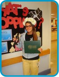 awardee wearing a headband of daisies, daisy award statue, and certificate.