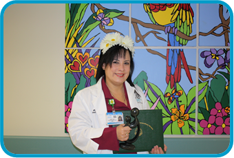 awardee wearing a headband of daisies, daisy award statue, and certificate.